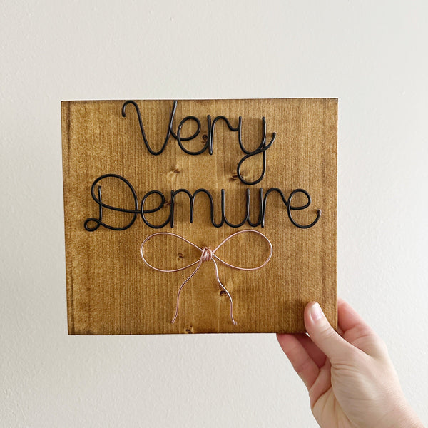 Demure Bow Sign