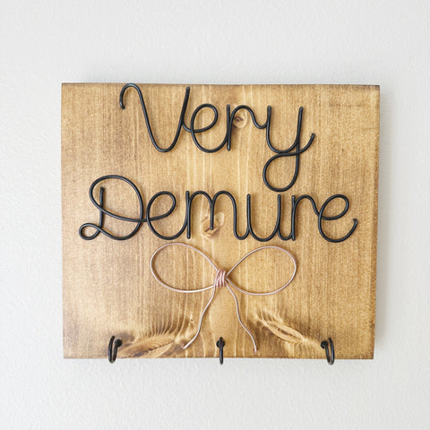 Demure Bow Sign