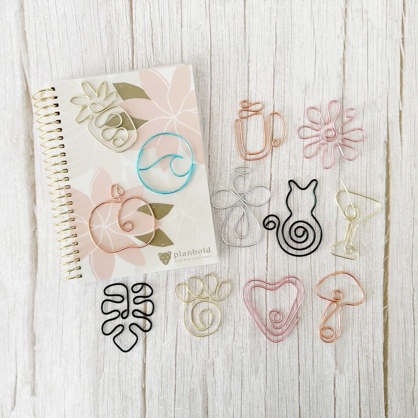 Notebook with decorative bookmarks on a wooden surface