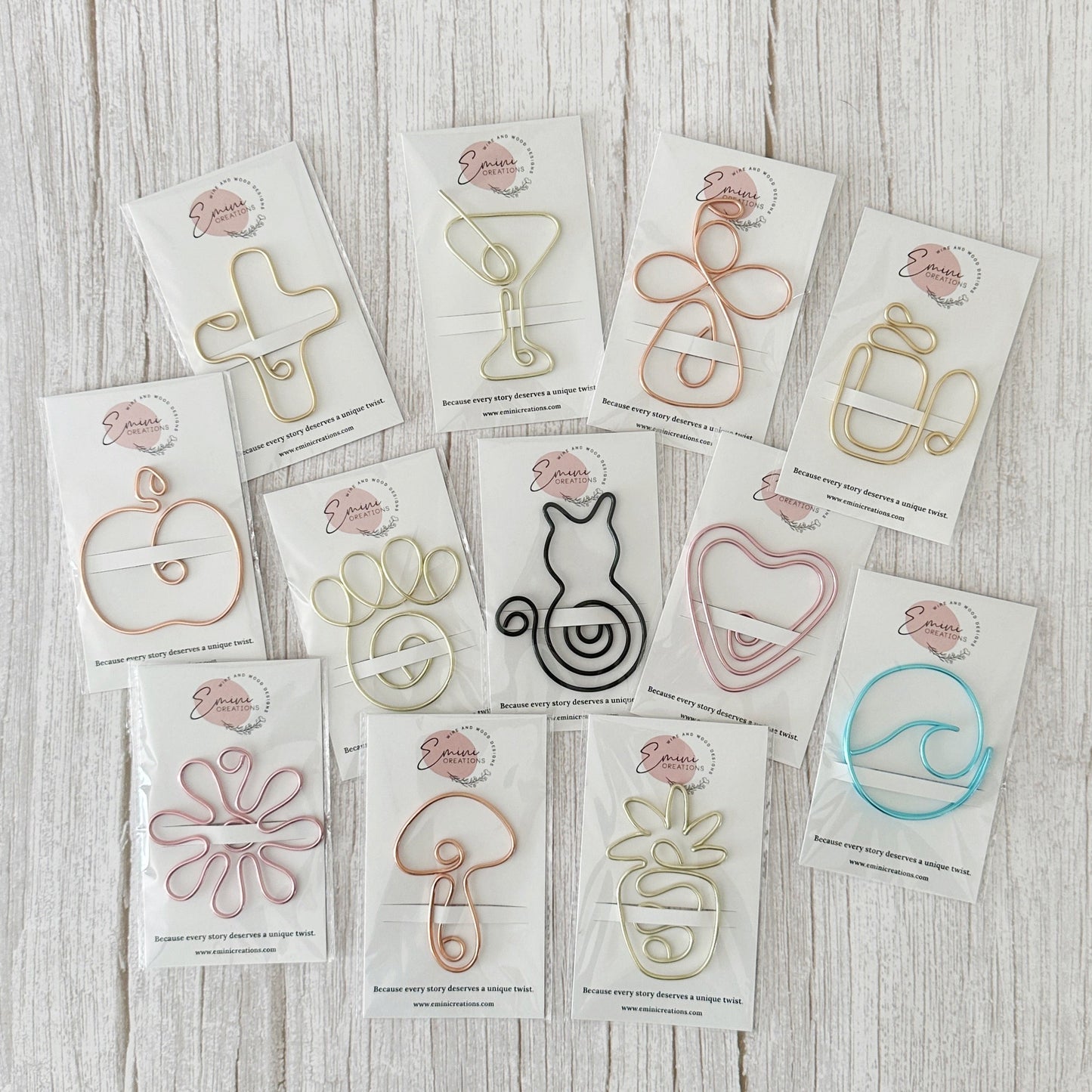 A collection of wire bookmarks or planner clips in a variety of colors attached to branded backing.