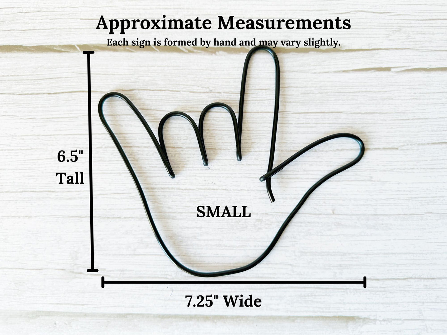 Measurement chart of a small hand-shaped wire sign on a light wooden background. The dimensions are: 6.5"Tall x 7.25"Wide.